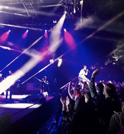 People enjoying music concert at night