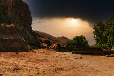 Scenic view of rocks against sky during sunset