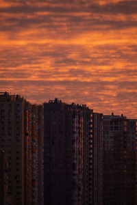 Low angle view of buildings against sky during sunset