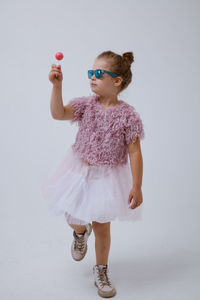 Full length of a girl holding white background