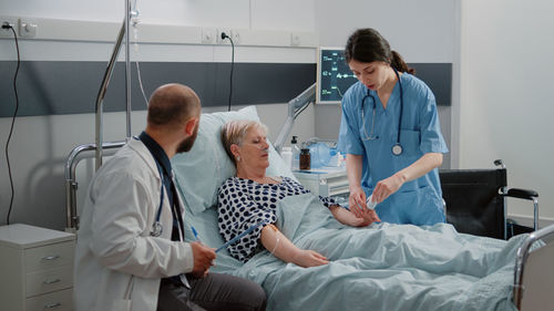 Female doctor examining patient at clinic