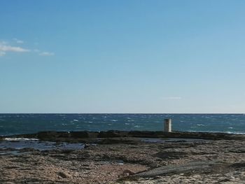 Scenic view of sea against clear blue sky