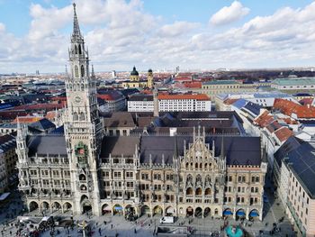 High angle view of buildings in city against cloudy sky