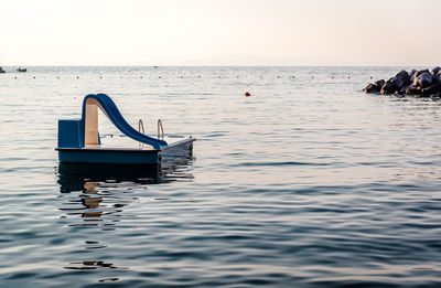 Lifeguard hut in sea against clear sky