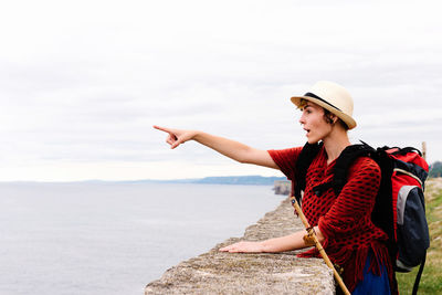 Young woman wearing hat against sky