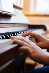 Midsection of man playing piano