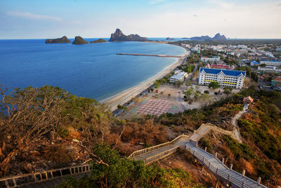 High angle view of buildings and sea against sky