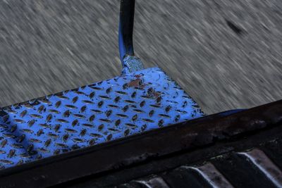 High angle view of wet metal on footpath