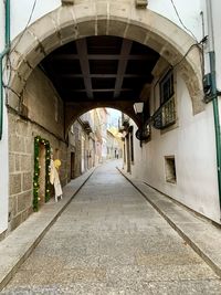 Empty street amidst buildings in city