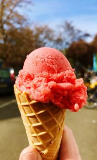 Close-up of hand holding ice cream cone