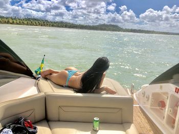 Woman relaxing on boat in sea