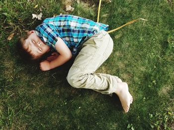 High angle view of man relaxing on field