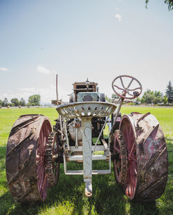 Rusty metallic structure on field against sky