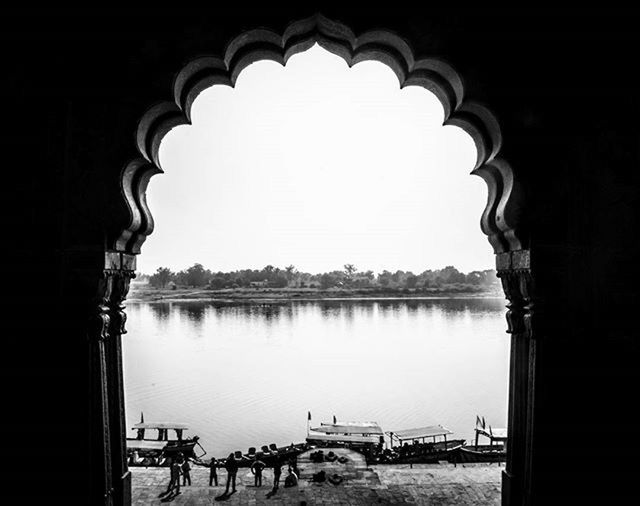 arch, clear sky, water, built structure, architecture, copy space, reflection, building exterior, river, archway, day, indoors, travel destinations, incidental people, tourism, sky, entrance, nature, no people