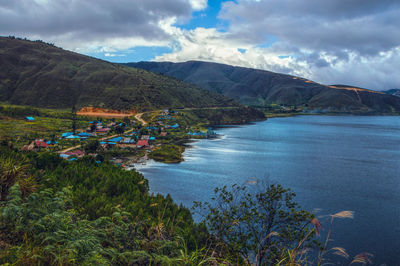 Scenic view of lake and mountains against sky
