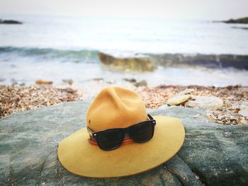 Sunglasses on rock at beach