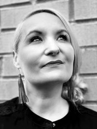 Close-up portrait of young woman against wall