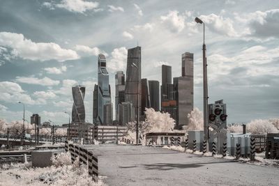 View of cityscape against cloudy sky during winter