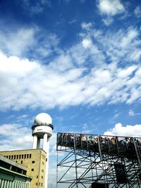 High section of built structure against blue sky