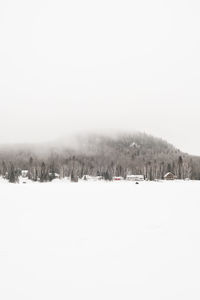 Scenic view of snow covered field against clear sky