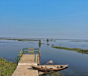 Boats moored in sea against sky