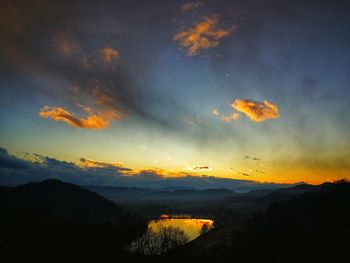 Scenic view of silhouette mountains against sky at sunset