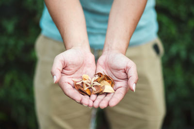 Midsection of man holding flowers