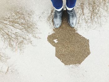 Low section of man standing on ground