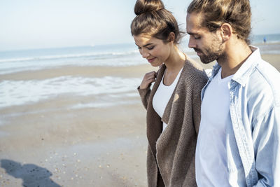 Young couple standing on beach