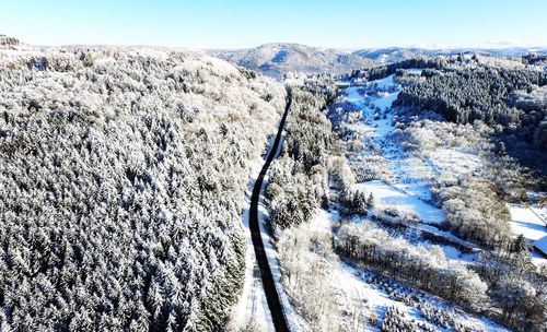 Scenic view of snow covered mountains against clear sky