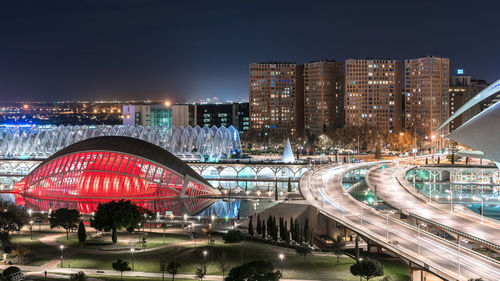 Illuminated city against sky at night