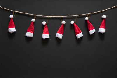 Clothes hanging on clothesline against black background