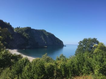 Scenic view of sea against clear blue sky