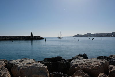 Scenic view of bay against clear sky