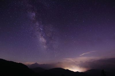 Scenic view of starry sky on silhouette mountains