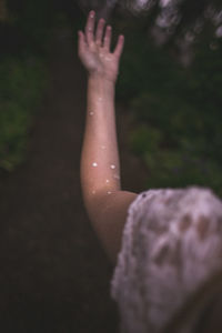 Close-up of hand against water