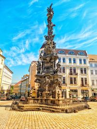 Low angle view of statue in city against sky
