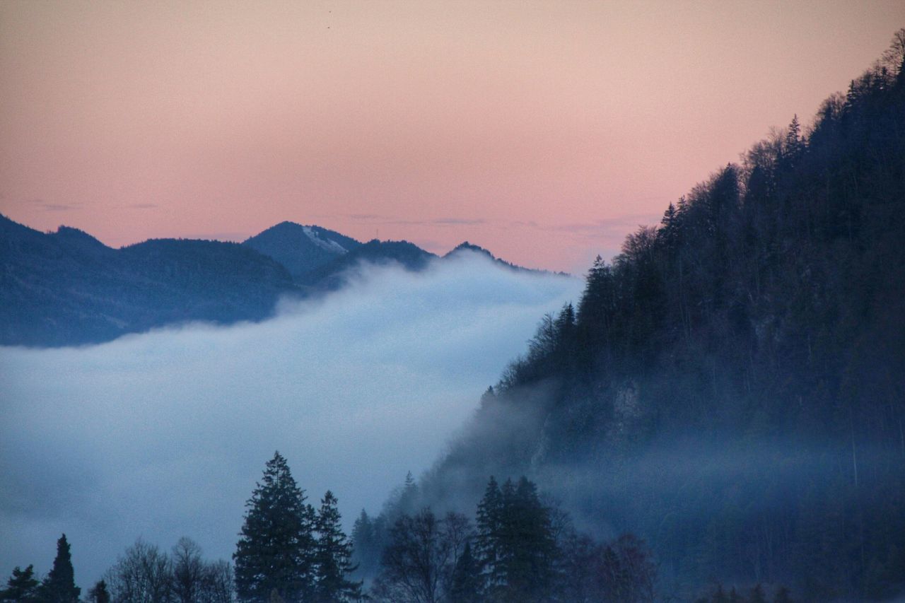 scenics, tranquil scene, mountain, tranquility, beauty in nature, tree, fog, sky, nature, sunset, weather, mountain range, silhouette, idyllic, dusk, landscape, non-urban scene, winter, majestic, cloud - sky