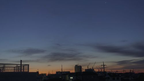 Low angle view of silhouette buildings against sky during sunset