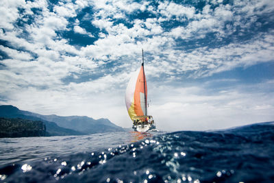 Boat sailing on sea against sky