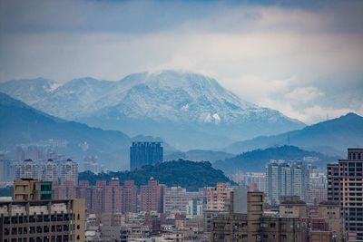 Cityscape against cloudy sky