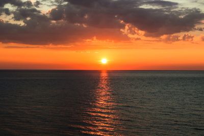 Scenic view of sea against romantic sky at sunset