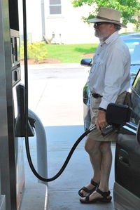 Side view of man standing at bus