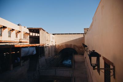 Man and buildings against clear blue sky