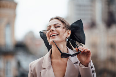 Portrait of a smiling young woman in city