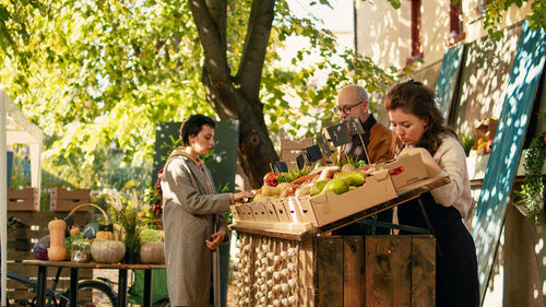 Side view of friends working at park