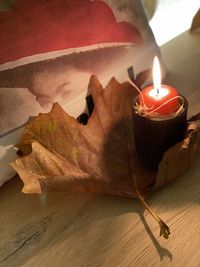 High angle view of lit candles on table