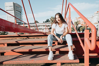 Young woman sitting on staircase