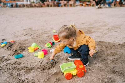 High angle view of boy playing with toy at beach