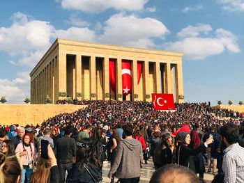 Group of people at stadium against sky